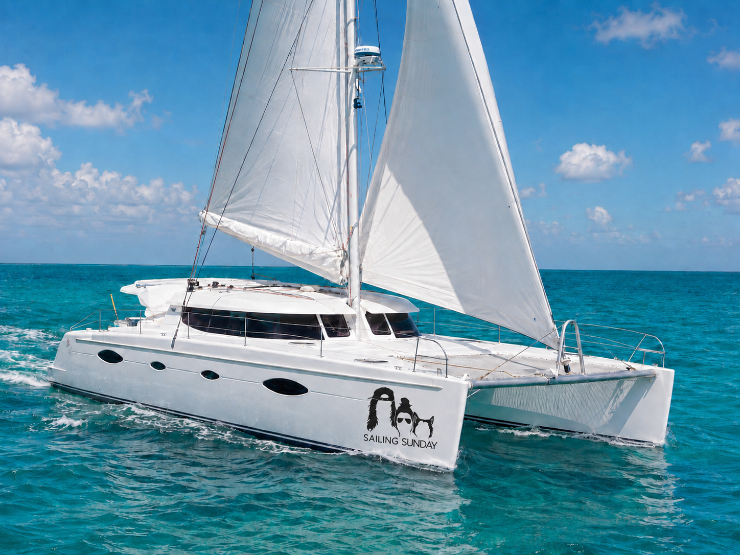 Our Sailing Sunday catamaran under sail in turquoise water
